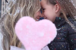Madison Torres stands outdoors with her 4-year-old daughter, Luna Torres, smiling together in a candid portrait that reflects connection and warmth.