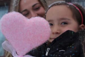 Madison Torres stands outdoors with her 4-year-old daughter, Luna Torres, smiling together in a candid portrait that reflects connection and warmth.